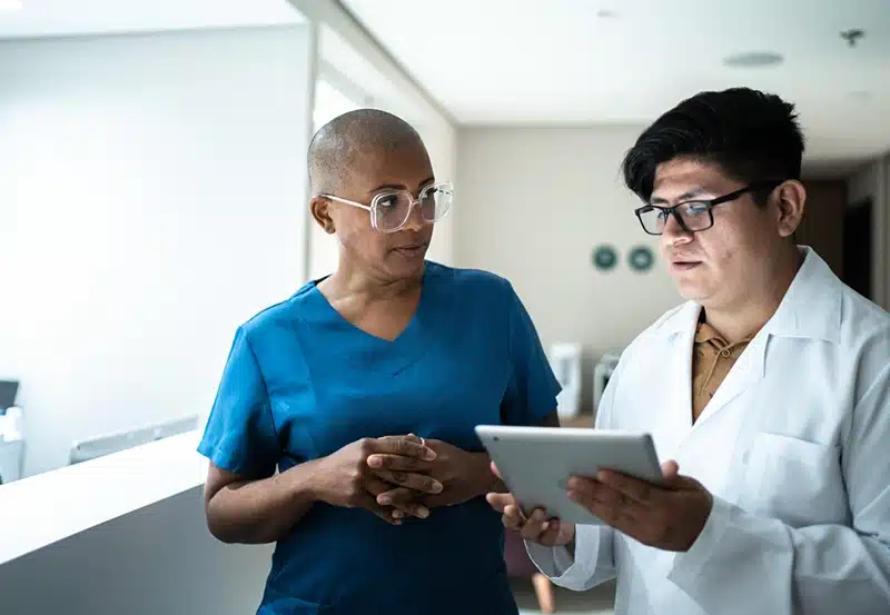 two healthcare workers looking at tablet